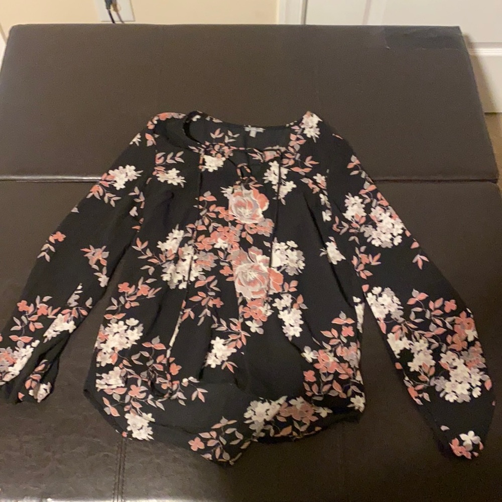 Floral blouse. Cris cross tie in front.